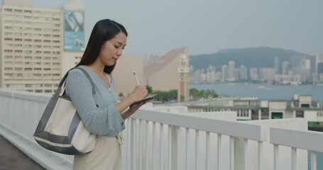 Wall Mural - Woman write on tablet computer in Hong Kong city