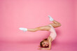© Татьяна Добрикова - Cute little girl workout in a  leotard on a pink background. Space for text.