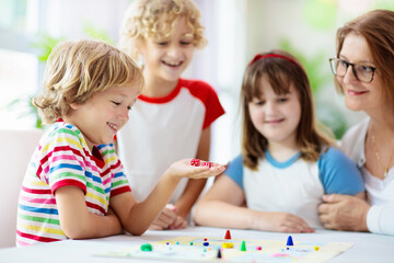 Wall Mural - Family playing board game. Kids play.