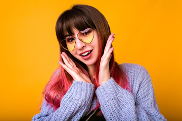 Wall Mural - Young stylish wonderful hipster woman with long ombre fuchsia hairs posing at studio