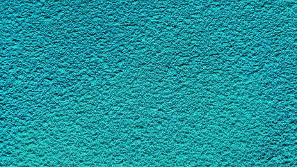 special light blue spray painted plaster close-up, texture, background for architectural building facade. rough grained cement wall background.