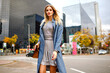 ©  AnnaHar - Outdoor fashion lifestyle portrait of blonde pretty young businesswoman,