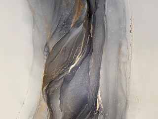 Fototapeta Abstract grey art with gold — black and white background with beautiful smudges and stains made with alcohol ink and golden paint. Grey fluid texture resembles marble, smoke, watercolor or aquarelle.