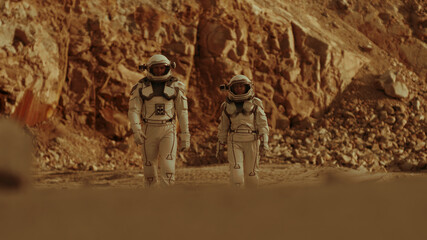 Wall Mural - Male and female cosmonauts walking on Mars