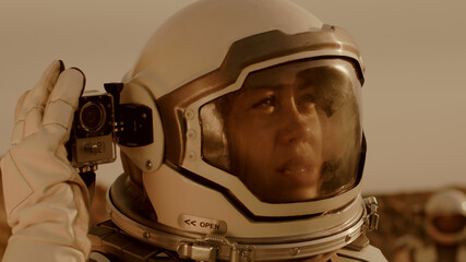 Wall Mural - Female astronaut shooting terrain of Mars