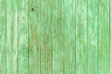 Weathered Green Barn Wall. Old Bright Green Vertical Wooden Plank With Painted Nails. Aged Green Fence. Vintage Unevenly Painted Green Chipboard Floor. Retro Green Timber Railing