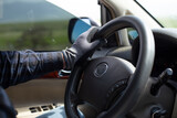 Fototapeta  - Close-up of hands on steering wheel while driving a car