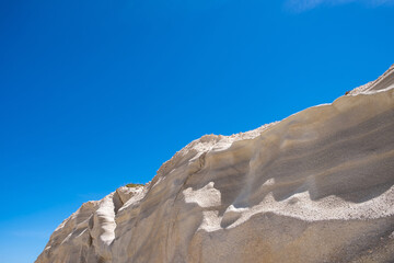 Wall Mural - Lunar landscape at Sarakiniko beach, Milos island, Cyclades Greece, Abstract natural rock shapes. White stone formation, blue sky backgroynd.