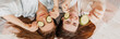 © Daria Lukoiko - Two girls make homemade face and hair beauty masks. Cucumbers for the freshness of the skin around the eyes. Women take care of youthful skin. Girlfriends laugh at home lying on the floor on pillows.