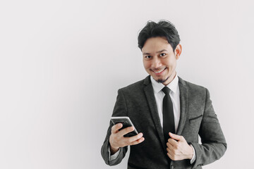 Happy smile face of Asian businessman use smartphone in concept of trading app.