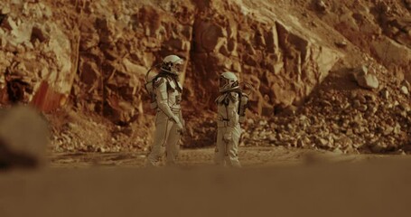 Wall Mural - Astronauts speaking near mountain ridge on Mars