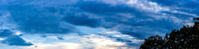 Blue Sky Panorama With Dark Blue Clouds In The Evening On The Tree