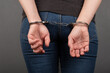 woman chained in handcuffs back view