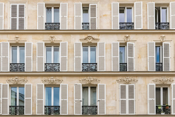 Paris, beautiful facade in the Marais, detail of the windows
