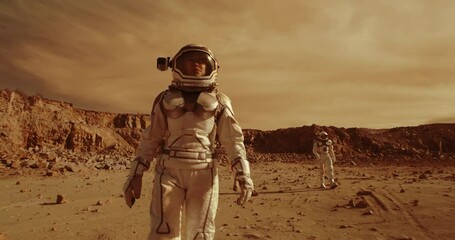 Wall Mural - Female astronaut walking on Mars near colleague