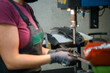 © .shock - woman wearing mask due to coronavirus pandemic while working in modern metal industry and using drill