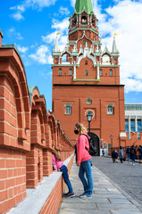 Wall Mural - Family visit Moscow Kremlin, Moscow, Russia. View to entrance for tourists. 