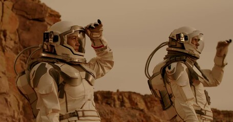 Wall Mural - Male and female cosmonauts looking around