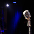 © Tetra Images - Vintage stage mic in spotlight
