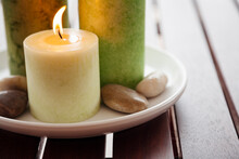 Close-up Of Candles And Stones On Plate