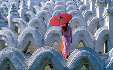 Myanmar, Mingun, Mandalay Division, Buddhist Nun Standing On White Arches Of Hsinbyume Pagoda