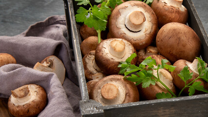 Wall Mural - Champinion mushrooms on dark background. Vegan food concept.