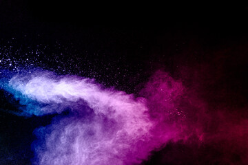 Wall Mural - pink blue dust particles splash on black background.pink blue powder splash.
