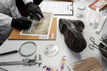 Police Scientist Investigates A Shoe Sole Tape Tread Involved In Crime Lab Murder, Concept Image