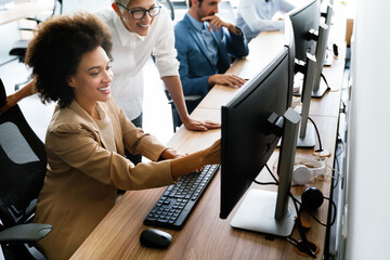 Happy business people having fun and chatting at workplace office