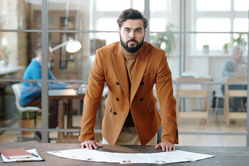 Canvas Print - Portrait of bearded recruiter at table with resumes