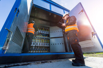 Wall Mural - checking the operating voltage levels of the solar panel switchgear compartment