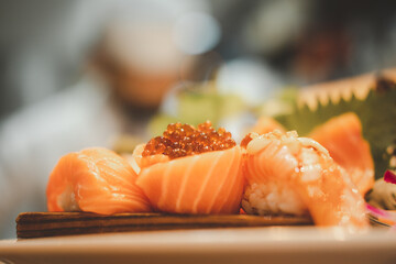 Wall Mural - Tasty fresh Japanese salmon sushi with chef