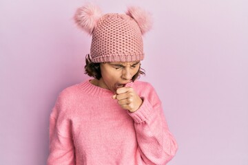 Wall Mural - Young brunette woman wearing cute wool cap feeling unwell and coughing as symptom for cold or bronchitis. health care concept.