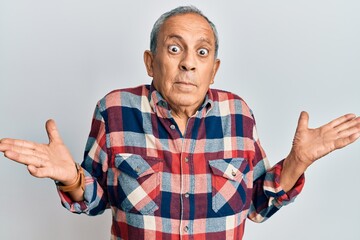 Canvas Print - Senior hispanic man wearing casual clothes clueless and confused with open arms, no idea and doubtful face.