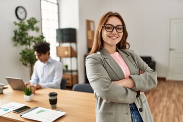 Canvas Print - Business manager smiling happy with arms crossed gesture. Employee working at the office.