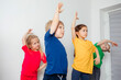 © oksix - Kids doing stretching exercises before gymnastic training