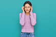 © Krakenimages.com - Young hispanic girl wearing casual clothes with hand on head for pain in head because stress. suffering migraine.