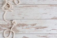 Sea Background With Marine Rope On White Wooden Deck Top View.