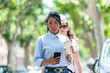 © JeanPaul - Beautiful afro american young woman walking in the street: Selective focus. Lifestyle concept.