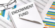 Notebook with text ENDOWMENT FUND . Diagram and white background