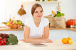 © volha_r - An attractive young woman looking for a new recipe for a delicious salad mix while sitting at the table in sunny kitchen. Tablet pc is the best cookbook