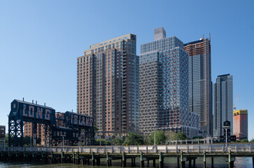 Wall Mural - Long Island City, NY - USA- June 13, 2021: A view of Gantry Plaza State Park, with transfer bridges, support gantries, and piers. on the East River in the Hunters Point section of Long Island City.