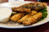 Fototapeta Tęcza - Deep Fried Pickles on a White Plate with Ranch Dressing on the Side