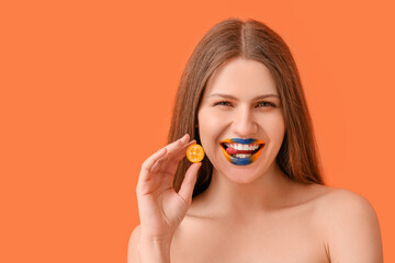 Wall Mural - Beautiful young woman with creative makeup and cumquat on color background