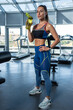 © nazarovsergey - Young sporty woman drinking water during workout at gym