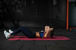 © nazarovsergey - Fit girl performing doing crunches during training at gym