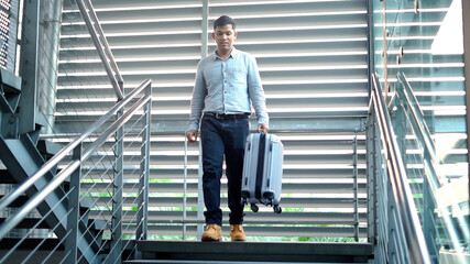 traveler man with suit case walking on stair