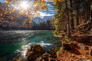 Fotomurali - Autumn nature landscape of mountain valley. Amazing Fusine lake with Picturesque sky in sunny day. Picture of wild area. Popular locations for travel and hiking. Concept of resting on outdoor.