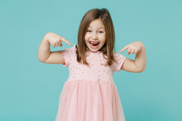 Wall Mural - Little fun cute kid girl 5-6 years old wears pink dress point index finger on herself isolated on pastel blue color background child studio portrait. Mother's Day love family people lifestyle concept.