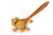 Brown sugar in wooden spoon, brown sugar cubes, top view